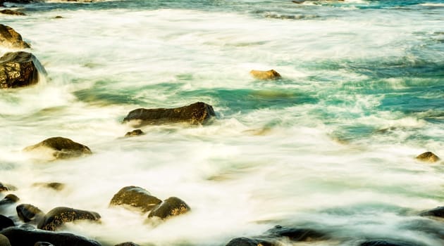 Surf of the Atlantic Ocean with rocks in long exposure