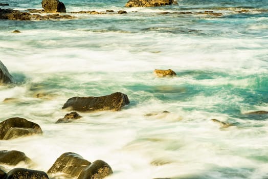 Surf of the Atlantic Ocean with rocks in long exposure