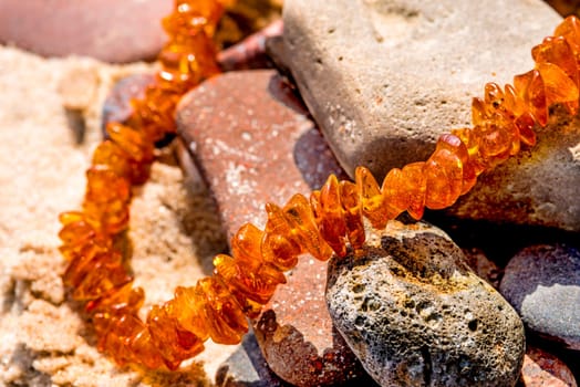 Amber chain on the Baltic Sea beach.