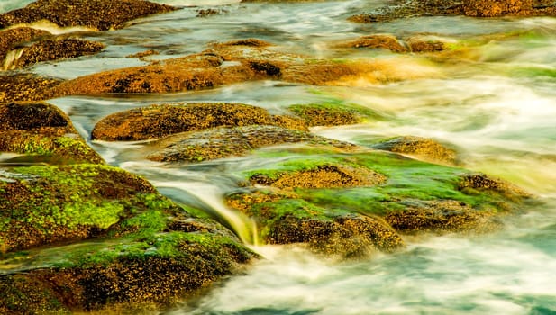 Surf of the Atlantic Ocean with rocks in long exposure
