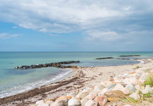 small sea barrier made of stones at the north side of sealand, denmark