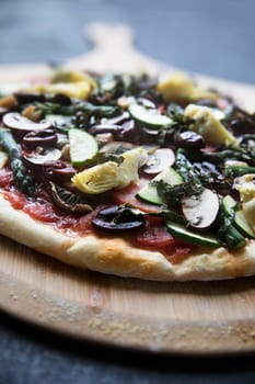 Homemade vegan pizza on pizza peel