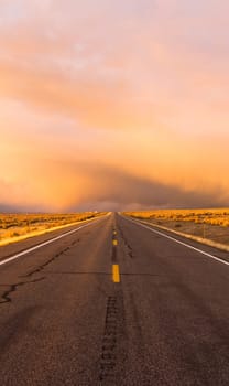 There are dramatic storm clouds ahead on this rural road