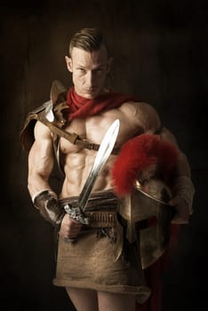 Ancient warrior or Gladiator posing over a dark background