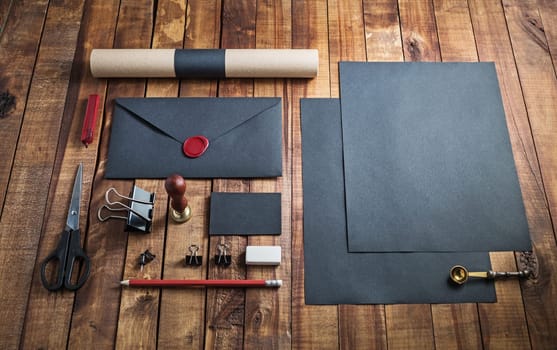 Blank black stationery set on vintage wooden table background.. Template for branding identity. For graphic designers presentations and portfolios.