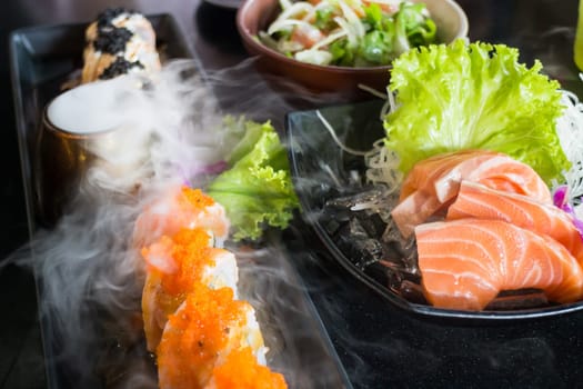 Set Of Salmon Menu Served On Black Plate, stock photo