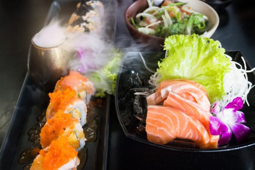 Set Of Salmon Menu Served On Black Plate, stock photo