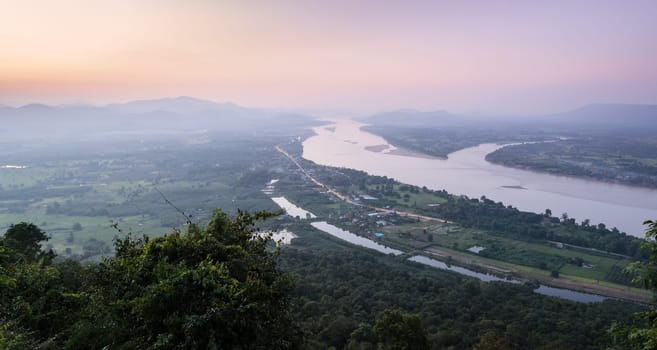 Aerial landscape view of Mekong river with mountain ranges at twilight in Nong Khai Province, Thailand