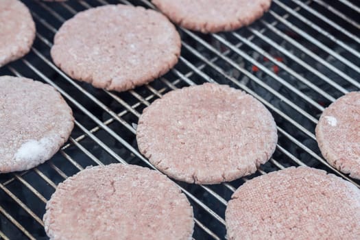 Frozen Hamburger Patties on Barbecue.