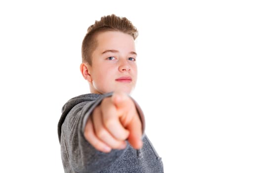 teenager in front of white background pointing in to the camera