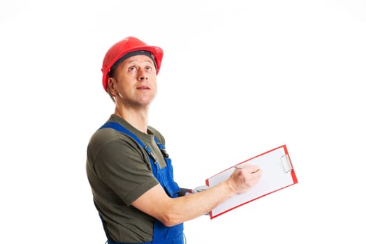 young workman in blue dungarees with clipboard in front of white background