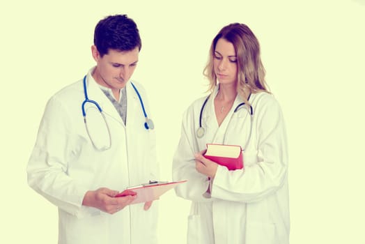 young friendly medical team with book in lab coat in front of clinic background
