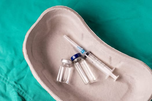 Medical Stethoscope lying on the hospital's green background. The background can be a textile part of a doctor or nurse's work uniform