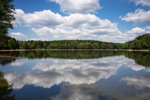 Idyllic lake with cloud reflection,landscape with lake and forest