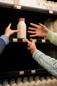 People reaching for milk