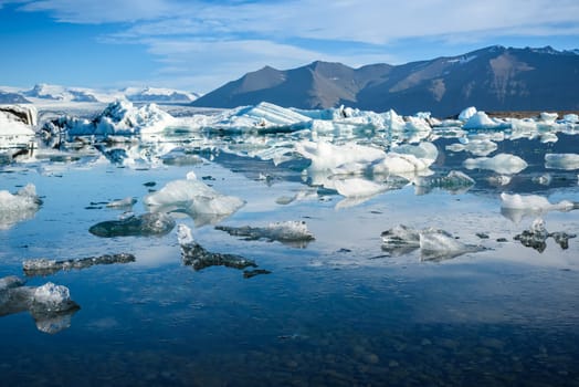 Beautiful view of icebergs in Jokulsarlon glacier lagoon, Iceland, global warming concept, selective focus
