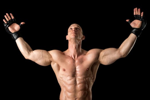 Strong Mixed Martial Arts fighter isolated in black