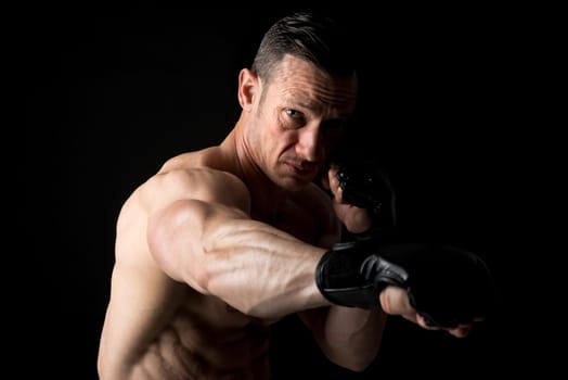 Strong Mixed Martial Arts fighter isolated in black