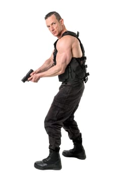 Man with tactical vest and gun isolated in white