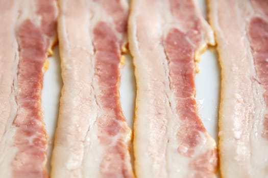 strip of fresh raw bacon close up, selective focus