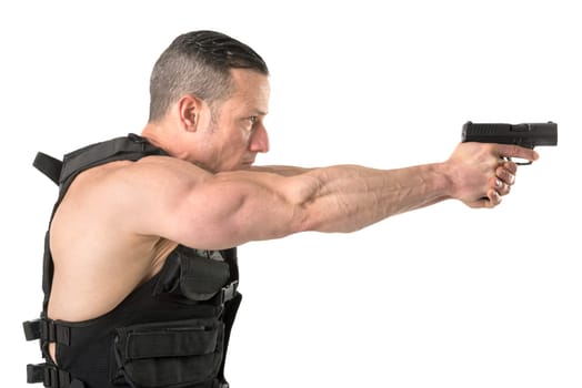 Man with tactical vest and gun isolated in white