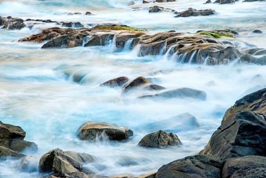 Surf of the Atlantic Ocean with rocks in long exposure