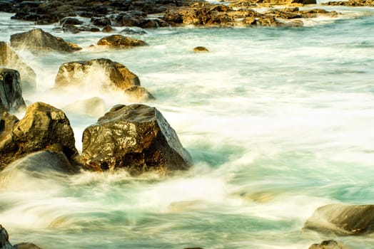 Surf of the Atlantic Ocean with rocks in long exposure