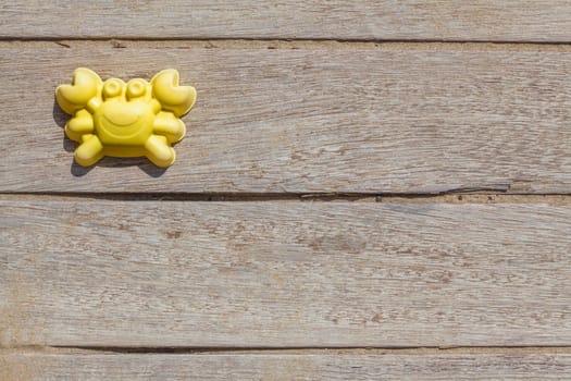 Children beach toy isolated on wood background on a sunny day