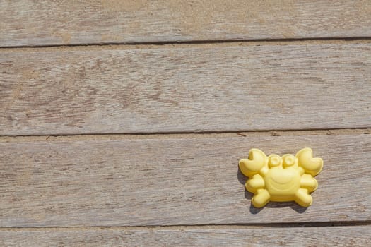 Children beach toy isolated on wood background on a sunny day
