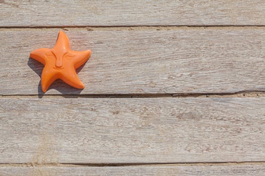 Children beach toy isolated on wood background on a sunny day
