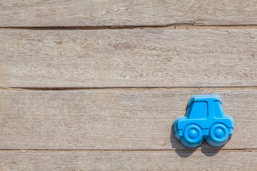Children beach toy isolated on wood background on a sunny day