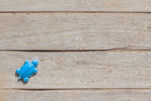 Children beach toy isolated on wood background on a sunny day