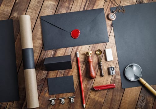 Blank black stationery set on wooden table background. ID template. Mockup for branding identity for designers. Top view.