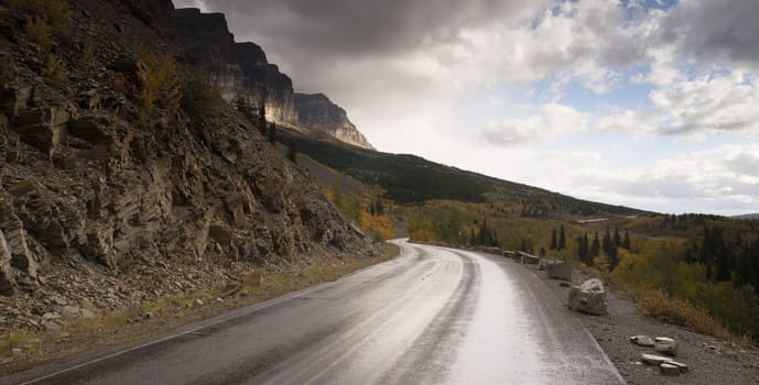 It's just starting to rain on the road in Glacier National Park
