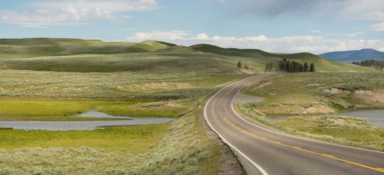 The road winds around the bend at Elk Antler Creek in Wyoming