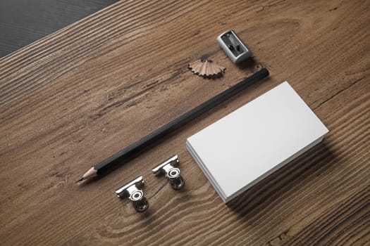 Bank business cards, pencil, and sharpener on wood table background. ID template Photo of blank stationery. Mock up for design portfolios.