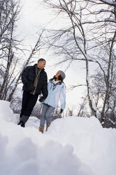 Mature couple walking through snow