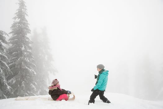 Mother and daughter with toboggan