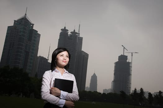Chinese businesswoman near skyscrapers
