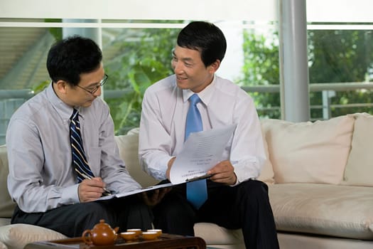 Two Chinese businessmen in a meeting