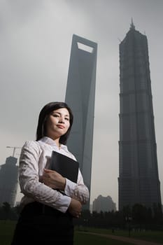 Chinese businesswoman near skyscrapers