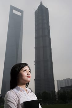 Chinese woman near skyscrapers