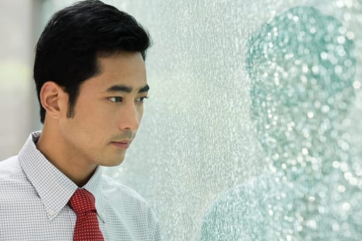 Businessman looking through window