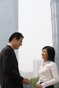 Two business colleagues near skyscrapers