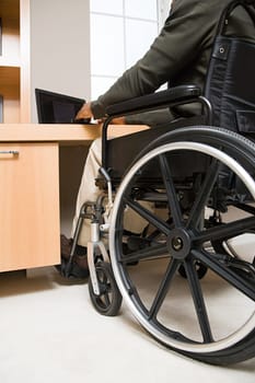 Rear view of a disabled man in a wheelchair