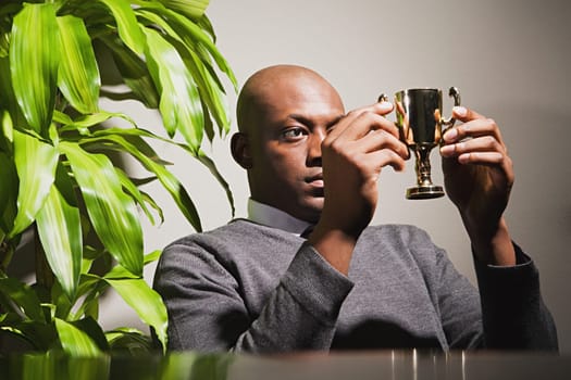 Businessman holding a trophy