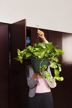 Business woman carrying plant