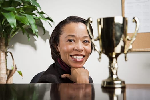 Business woman admiring her trophy