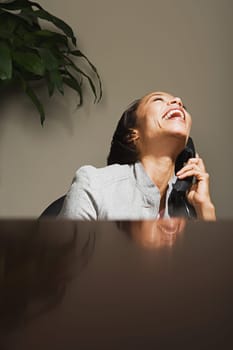 Business woman laughing on the telephone