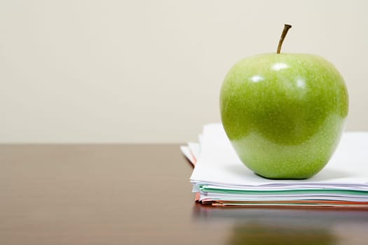 Apple on a pile of papers